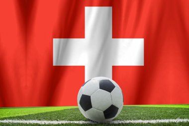 Futbol topu ve İsviçre'nin ulusal bayrak yatıyor yeşil g