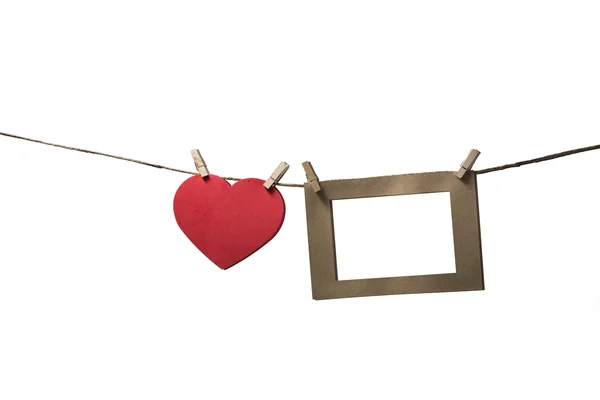 Blank instant photos hanging on the clothesline with red heart — Stock Photo, Image