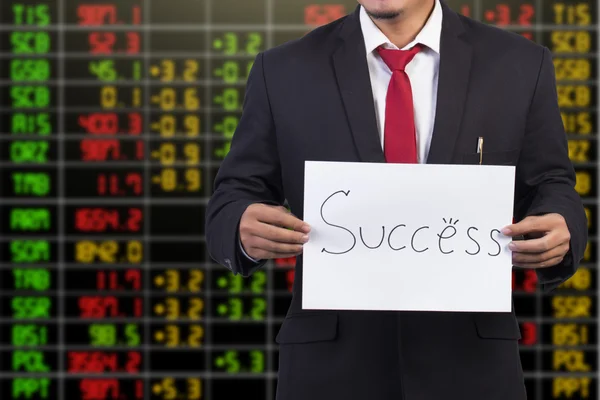 株式市場の背景に成功単語を示す実業家 — ストック写真