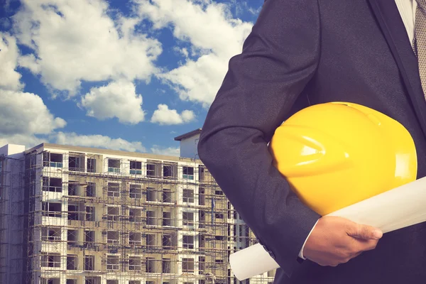 Engineer holding helmet for working at footing of building const — Stock Photo, Image