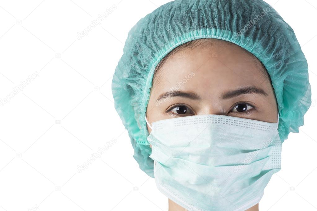 woman doctor looking at camera at hospital, close up shot on whi