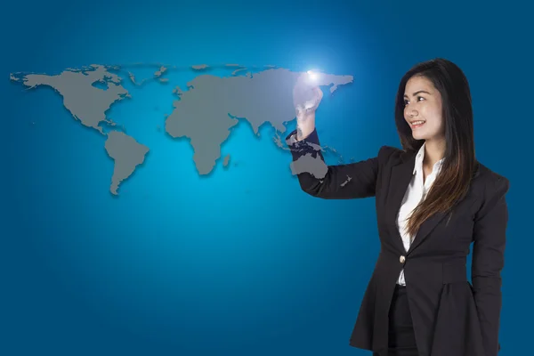 Business woman drawing the world map in a whiteboard