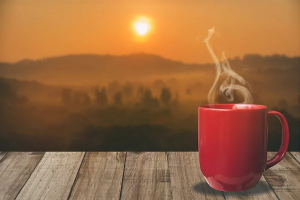 cup of coffee with mountain at morning sunrise.