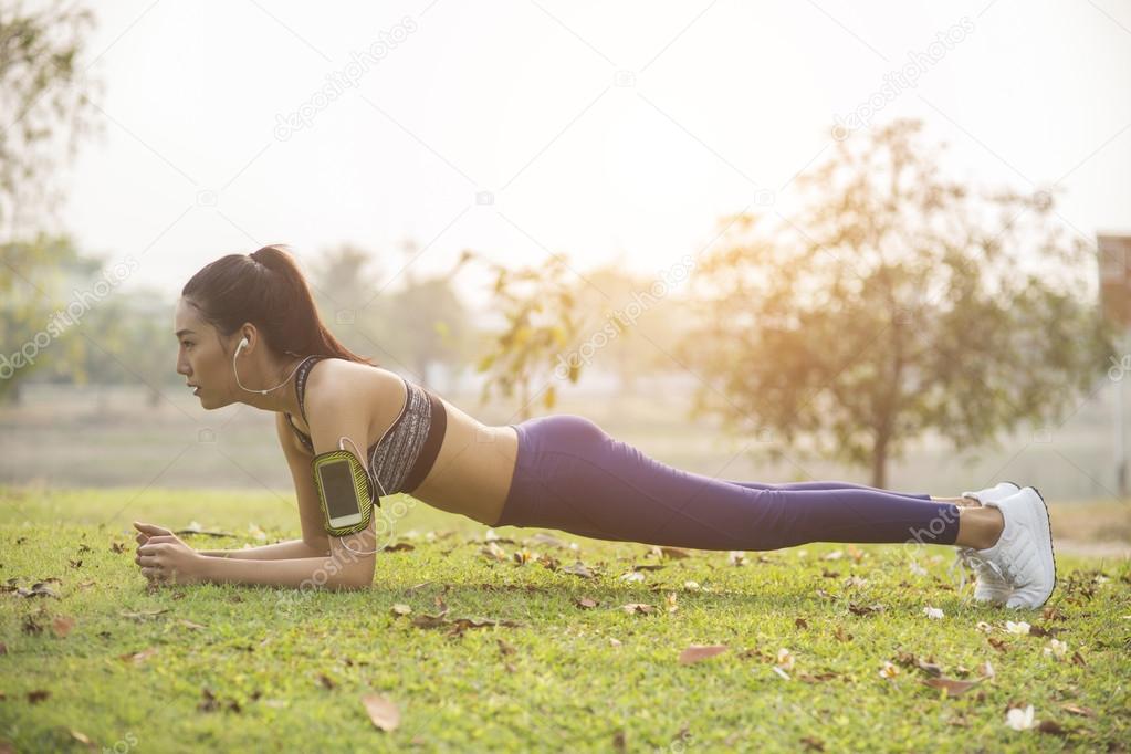 young woman, exercise in gardent background