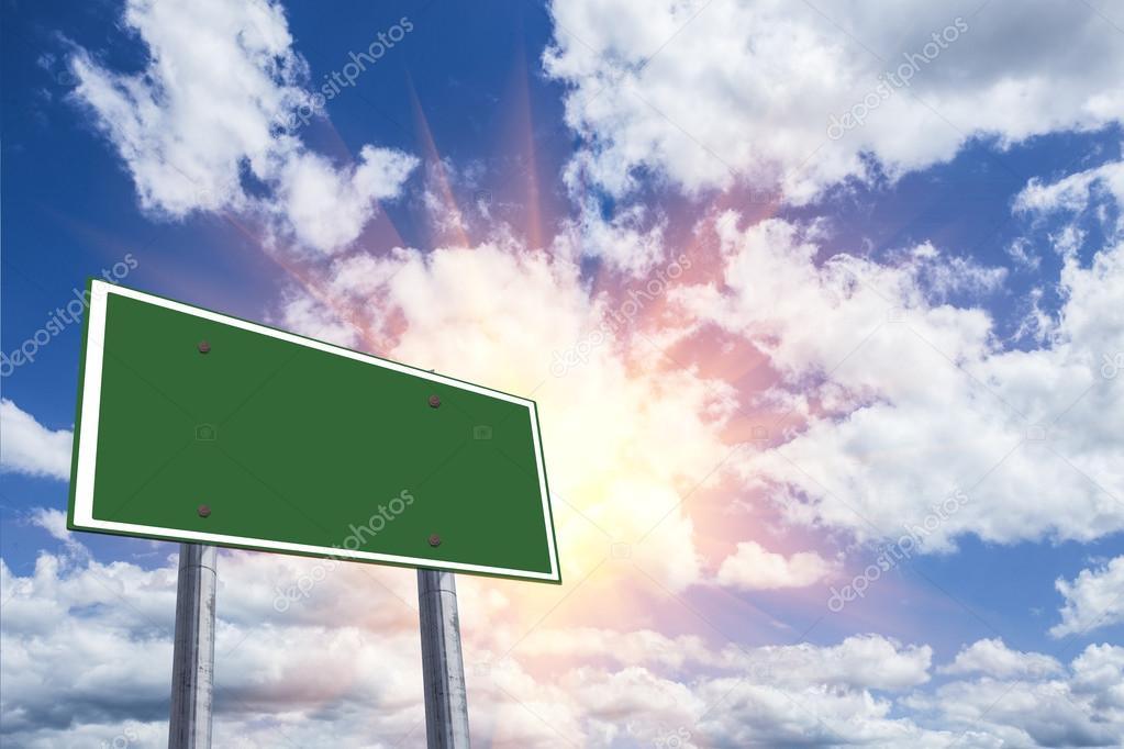 Blank freeway sign against a blue sky.