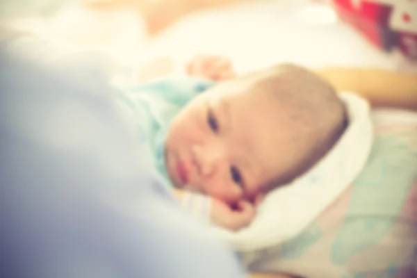 Blurry background Newborn baby in hospital post delivery room.Vi