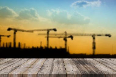 wood table top on blur background of construction site on vintag