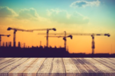 wood table top on blur background of construction site on vintag