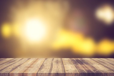 Wood table top on bokeh abstract background - can be used for mo