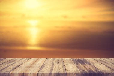 Wood table top on blur summer blue sea and sky background - can 
