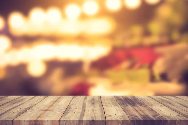 Image of wooden table in front of abstract blurred background of — Stock Photo, Image