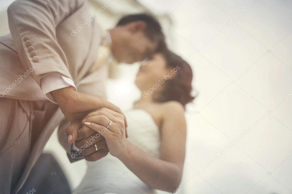 Wedding couple holding hands on sunset background.vintage color