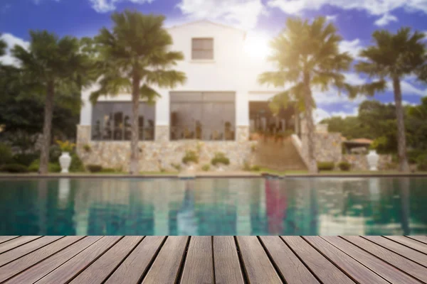 Wood desk table counter top with blurred swimming pool backgroun — Stock Photo, Image