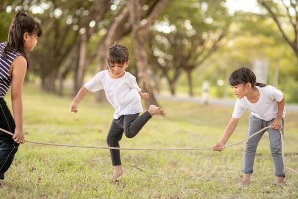 Happy Kids Playing Together Jumping Rope Outdoors — Stock Photo, Image