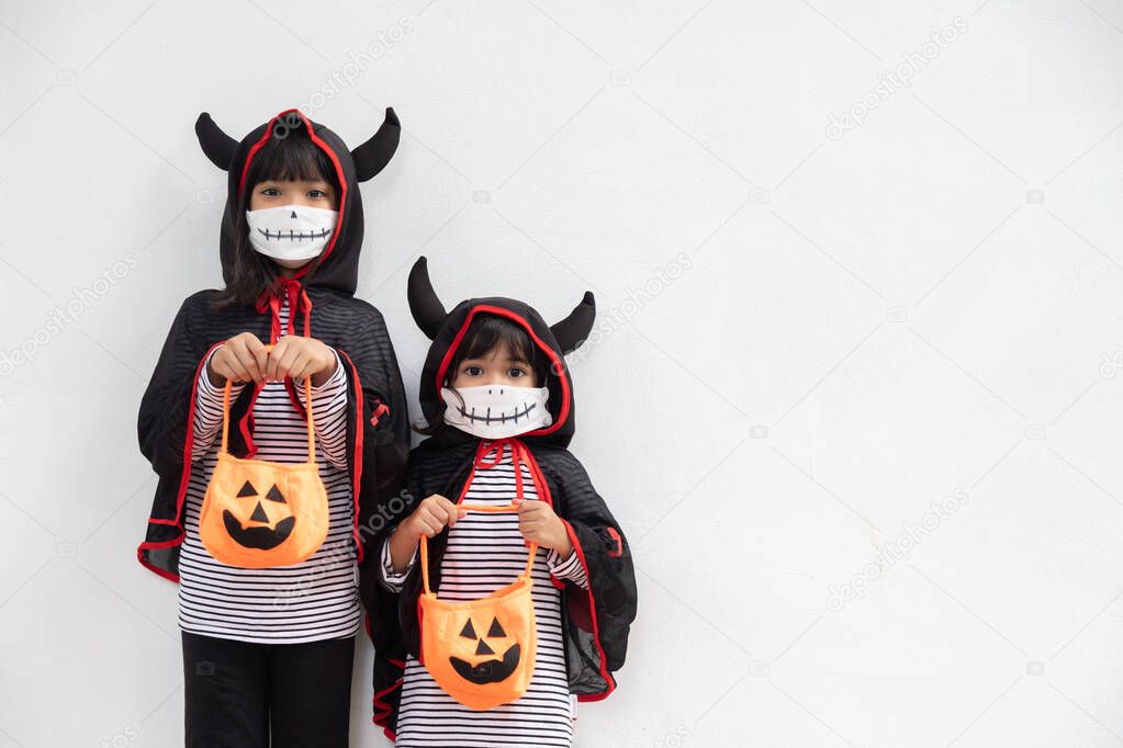 Happy sibling girls at the halloween party. children wearing costumes halloweens. concept of children ready for a party. 