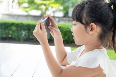 Akıllı telefon kullanan küçük kız, sosyal medya konsepti.