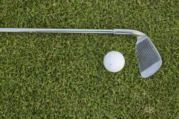 Golfový míček a golfová hůl na trávě — Stock fotografie