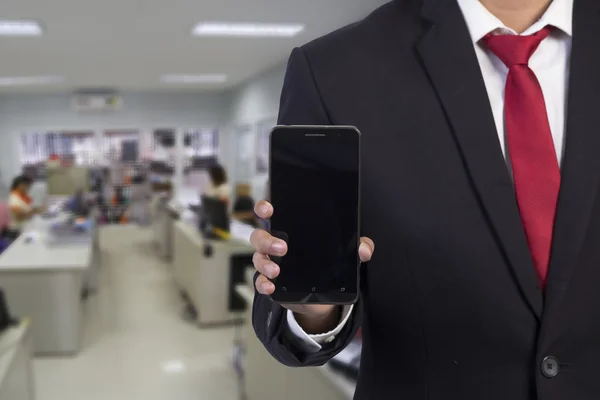 Zakenman met behulp van mobiele slimme telefoon op office achtergrond — Stockfoto