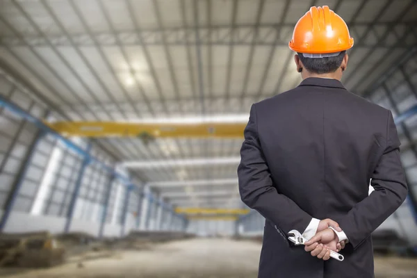 Engineer holding orange helmet for workers security on factory b — Stock Photo, Image