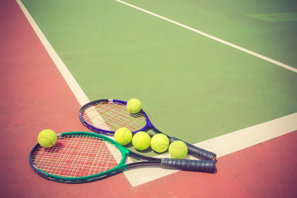 Tenisové rakety a míče na tenisový kurt vintage barvu — Stock fotografie