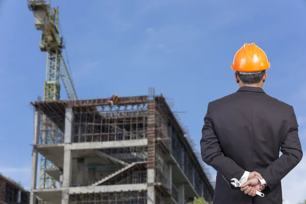 Engineer holding orange helmet for workers security on contructi — Stock Photo, Image