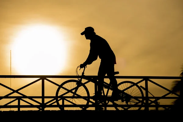 Silhouette of biker on Bridge and sunset — Stock Photo, Image