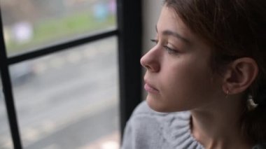 Genç bir kadın sigarasını ağzına alıyor.