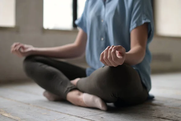Hand of meditating girl in lotus position, close-up without face