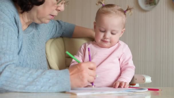Babcia uczy wnuczkę rysować, selektywnie się skupiać, zbliżyć — Wideo stockowe