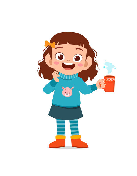 happy cute little kid drink hot chocolate in winter season. child drink milk wearing warm clothes