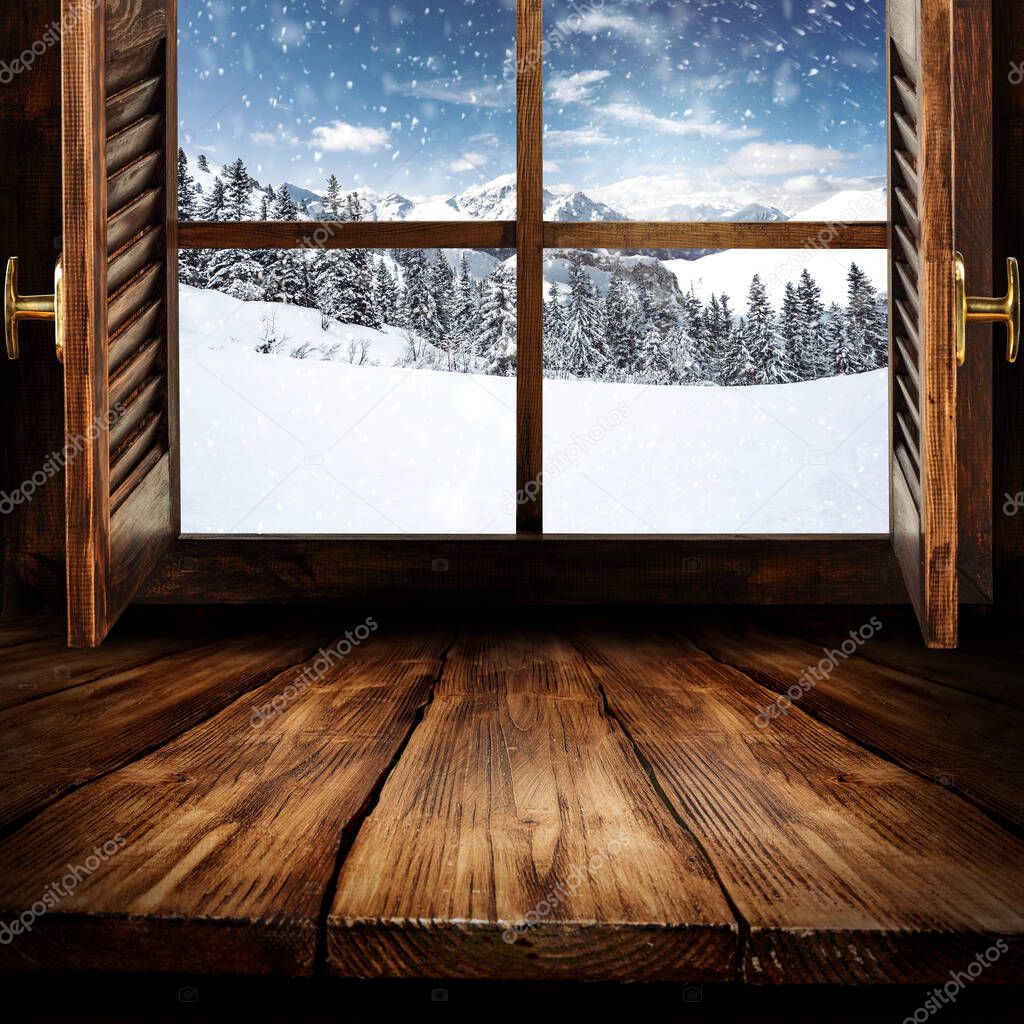 Blurred background of white winter window landscape and xmas table with empty space for your decorations and products.