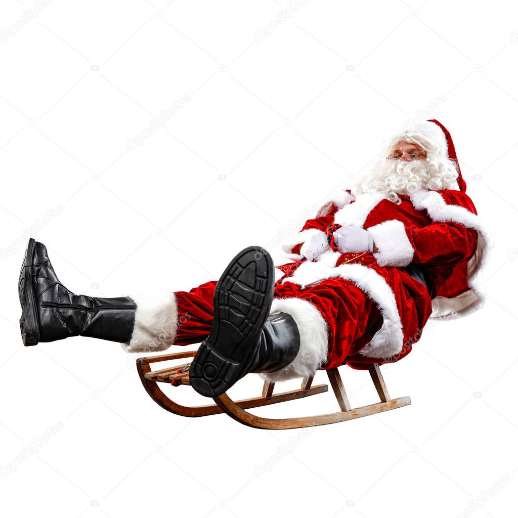 Santa Claus on his sleigh with a sack with presents. Winter snowy day with white snow background. Winter and Christmas time. Red Santa Claus riding a wooden sled. An older man with a beard delivers presents to a child.