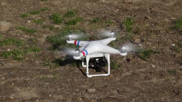 Close-up of quadcopter with mounted camera taking-off the ground for aerial photography/video in Sibiu, Romania. — Stock Video