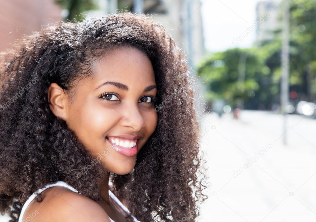 Amazing caribbean woman with curly hair in the city