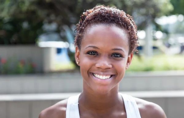 African american girl with short hair in city