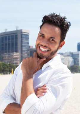Smart brazilian man with skyline in the background clipart
