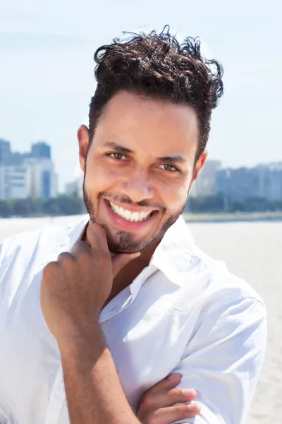 Laughing brazilian man with skyline in the background — Stock Photo, Image