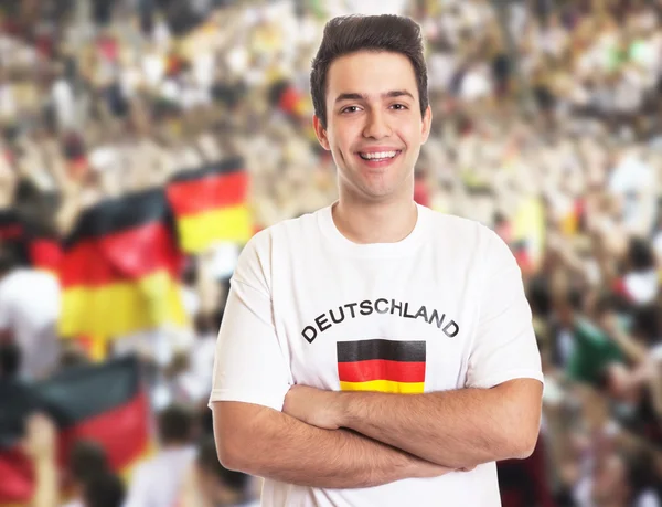 Handsome german fan with dark hair with other fans — Stock Photo, Image