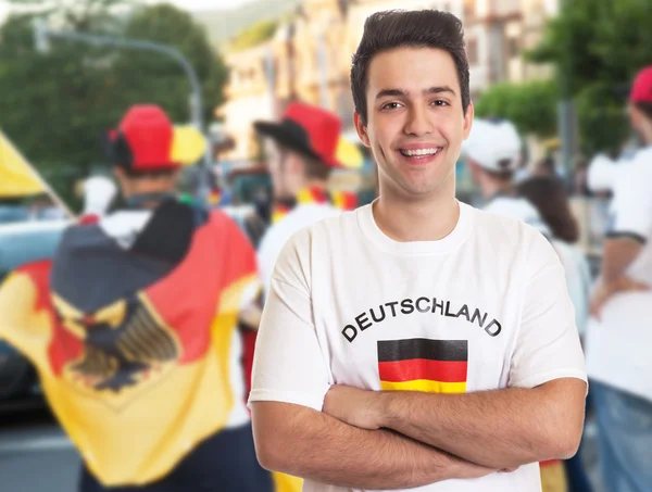 Cool german fan with dark hair with other fans — Stock Photo, Image