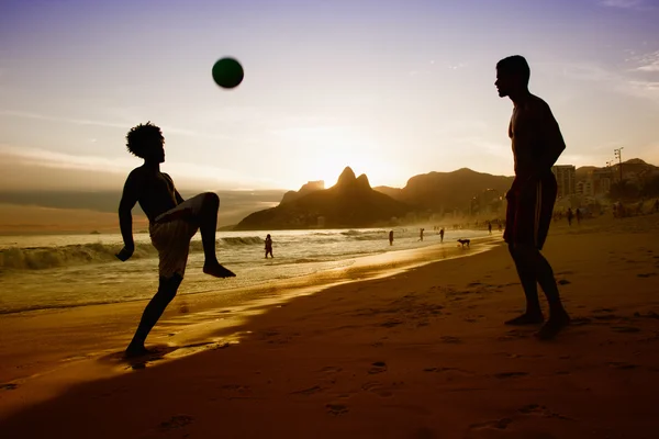 Twee jongens spelen met bal op strand in Rio de Janeiro — Stockfoto