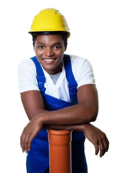 Laughing afro-americano trabalhador da construção civil com tubo — Fotografia de Stock