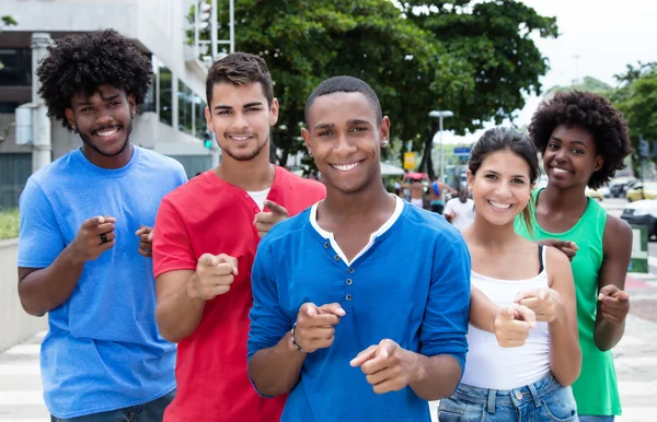 Group of international young adults pointing at camera — Stock Photo, Image