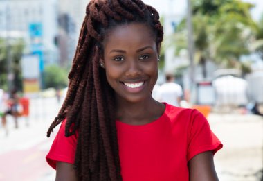 Awesome african woman with dreadlocks in the city clipart