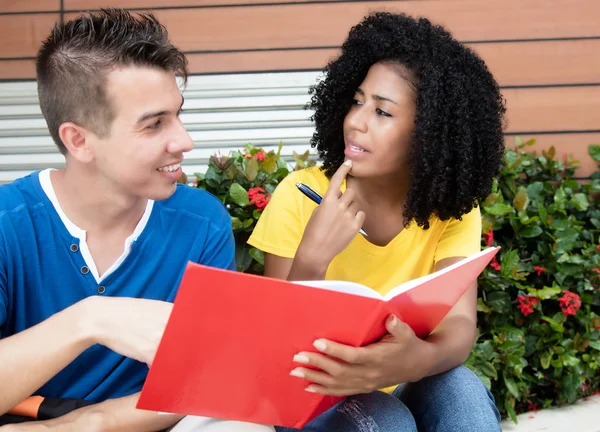 Caucasian male student learning with girlfriend Stock Photo