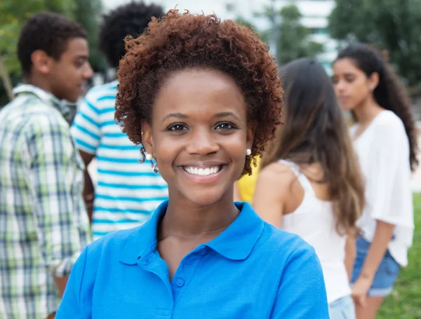 Laughing african american woman with multi racial group in the c — Stock Photo, Image