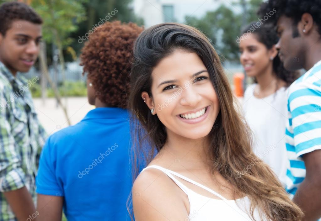 Laughing caucasian woman with multiethnic group in the city