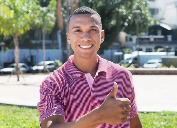 Mexican guy in the city showing thumb — Stock Photo, Image