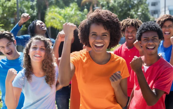 Large group of cheering young adults — Stock Photo, Image