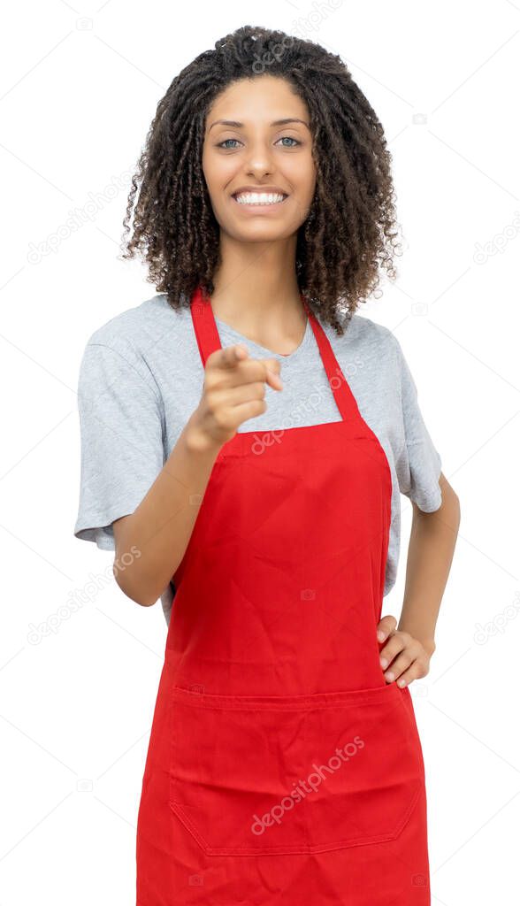 Laughing waitress or female clerk with curly hair and red apron isolated on white background for cut out