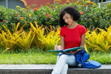 Üniversitenin kampüsünde öğrenim gören genç İspanyol kız öğrenci